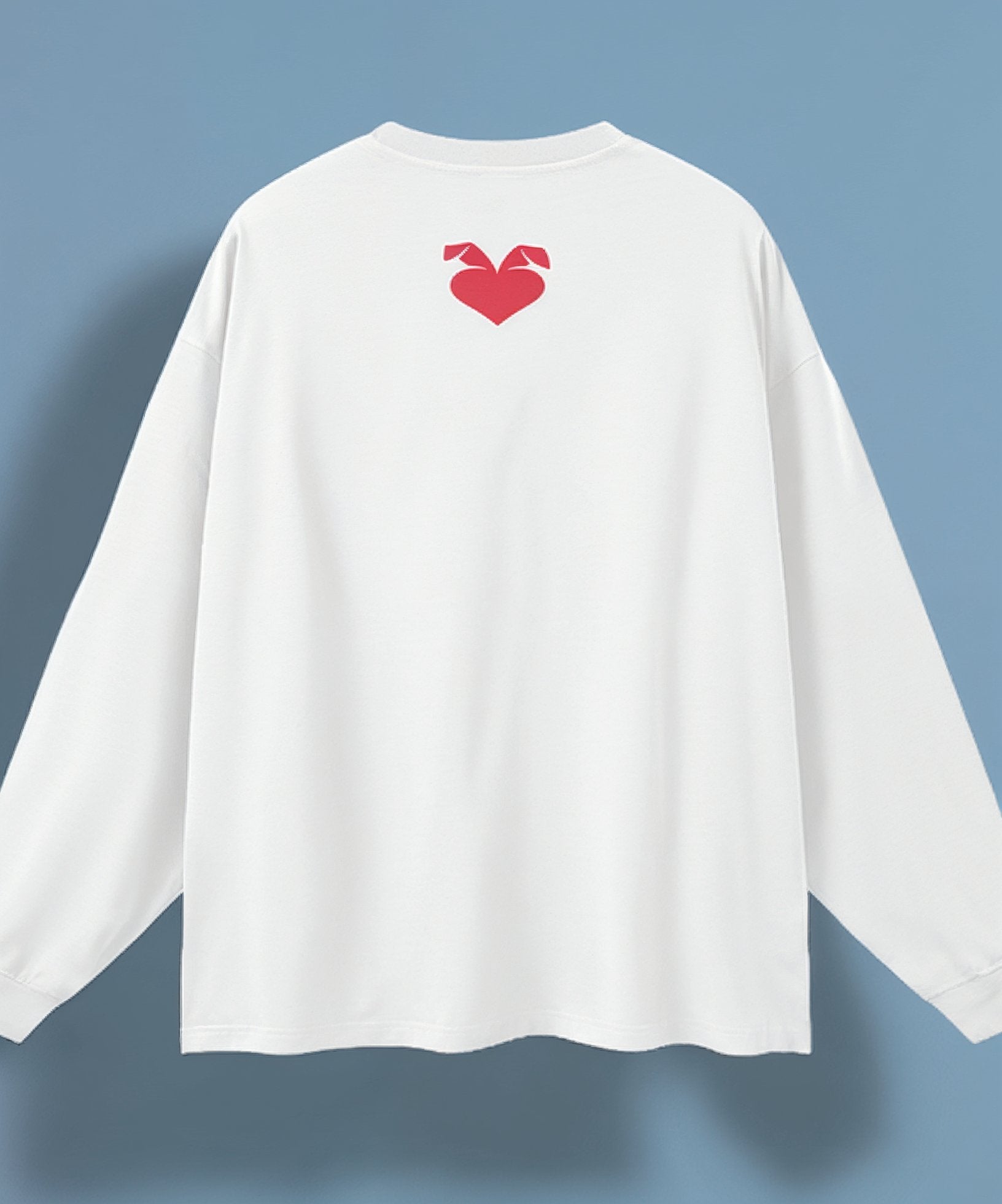 White long-sleeve shirt with a red heart design on the back against a blue background