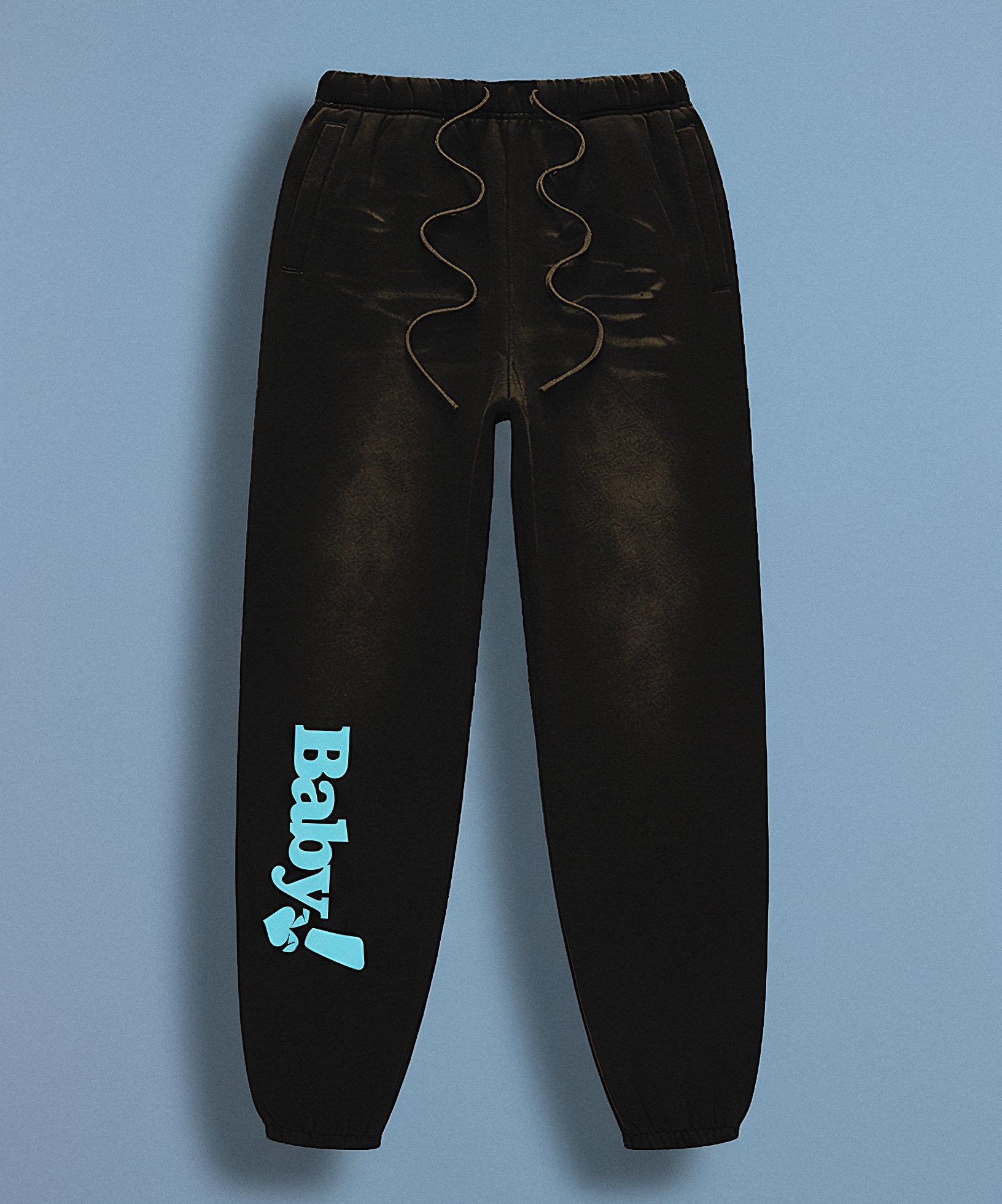 Black sweatpants with sweethearts 'Baby!' text on a gray background, front view