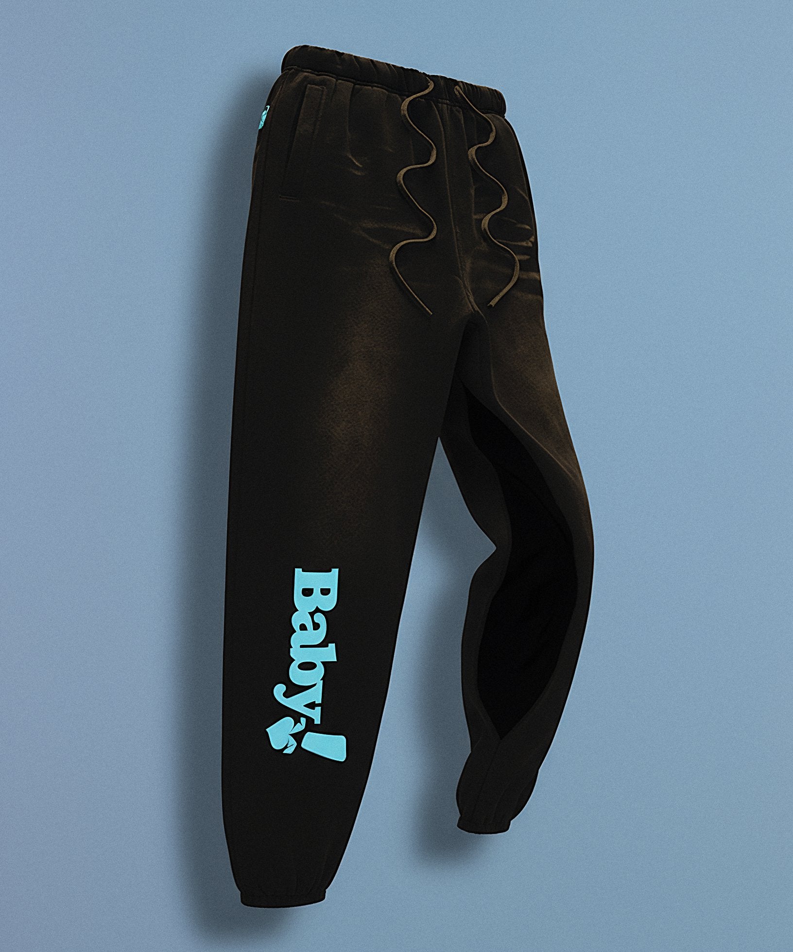 Black sweatpants with sweethearts 'Baby!' text on a gray background, side view