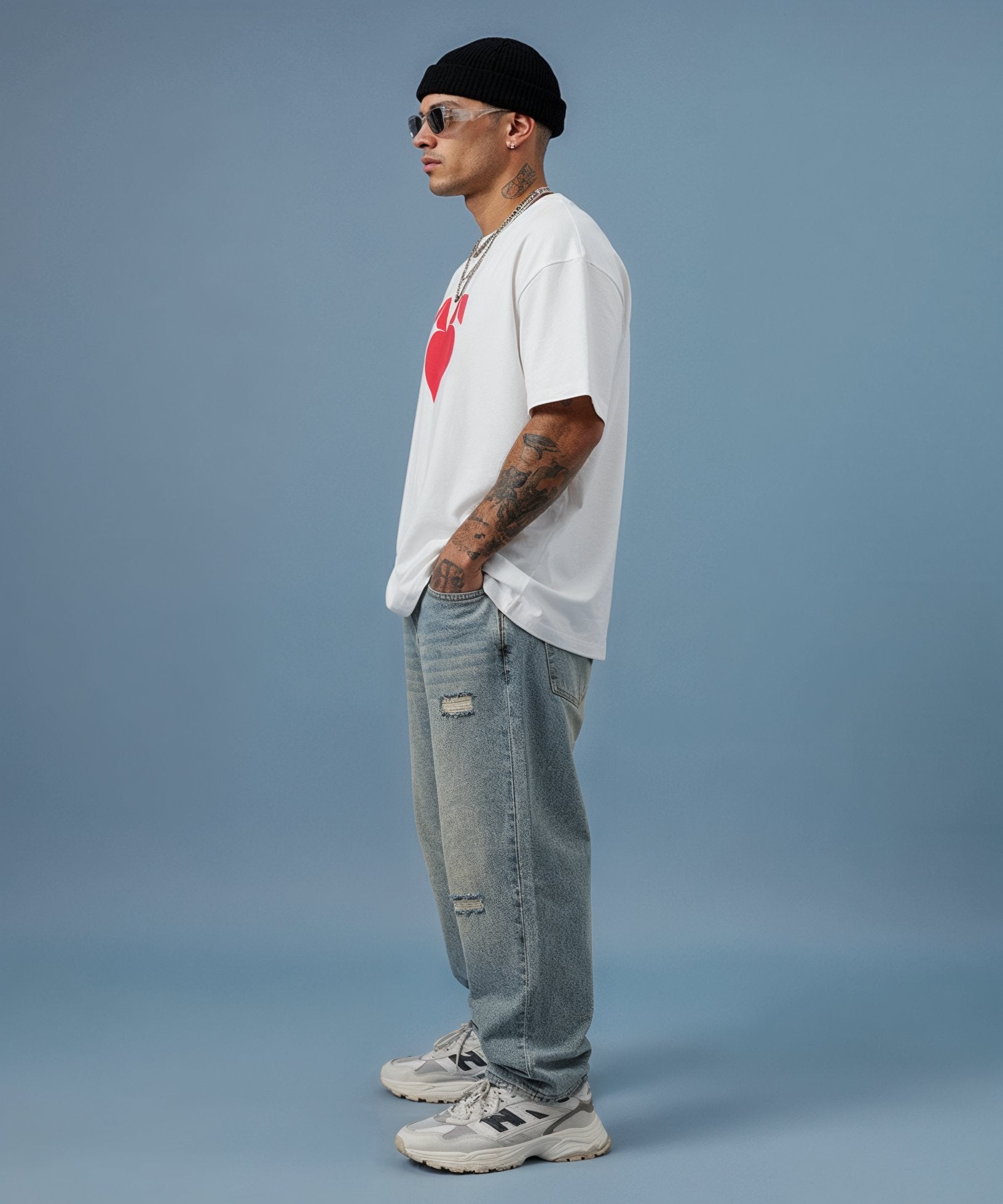 mmale model wearing white t-shirt with a red sweethearts logo heart design on a blue background, side view