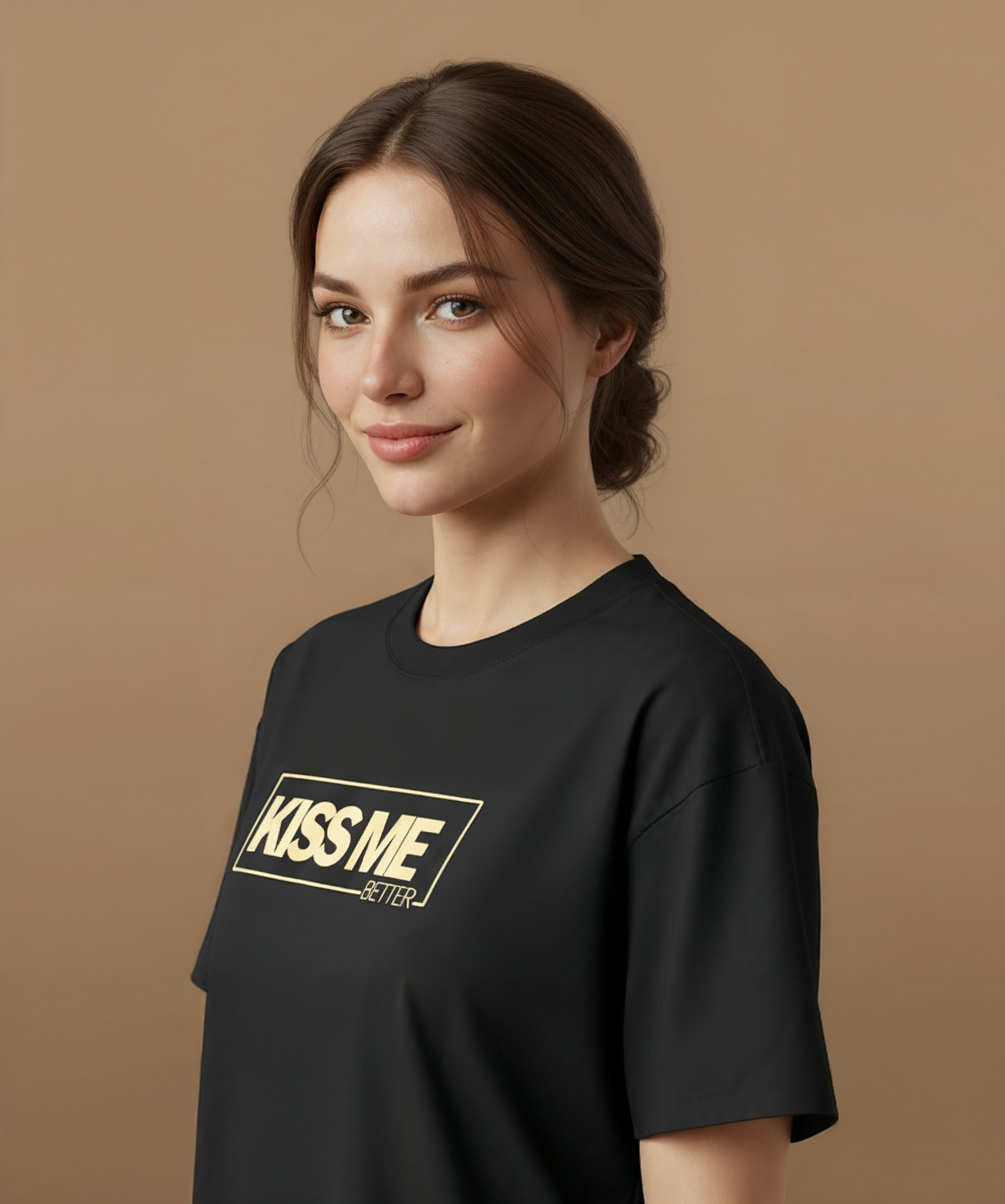 a female wearing a black t-shirt with 'KISS ME BETTER' text on a brown background, angled left