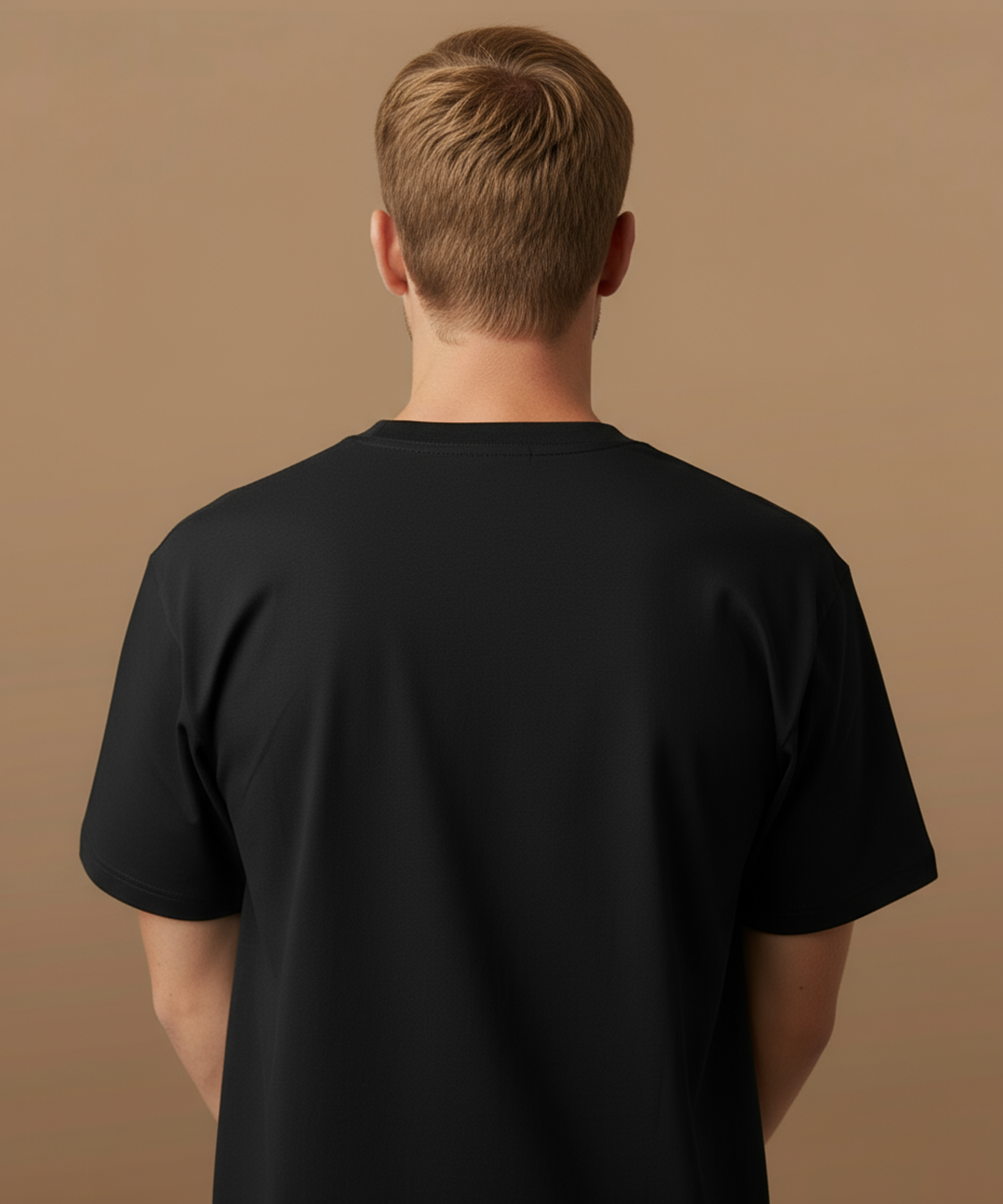 Male model wearing a black t-shirt with sweethearts brand 'SNACKS' printed in yellow from moods collection on a brown background. back of shirt in view