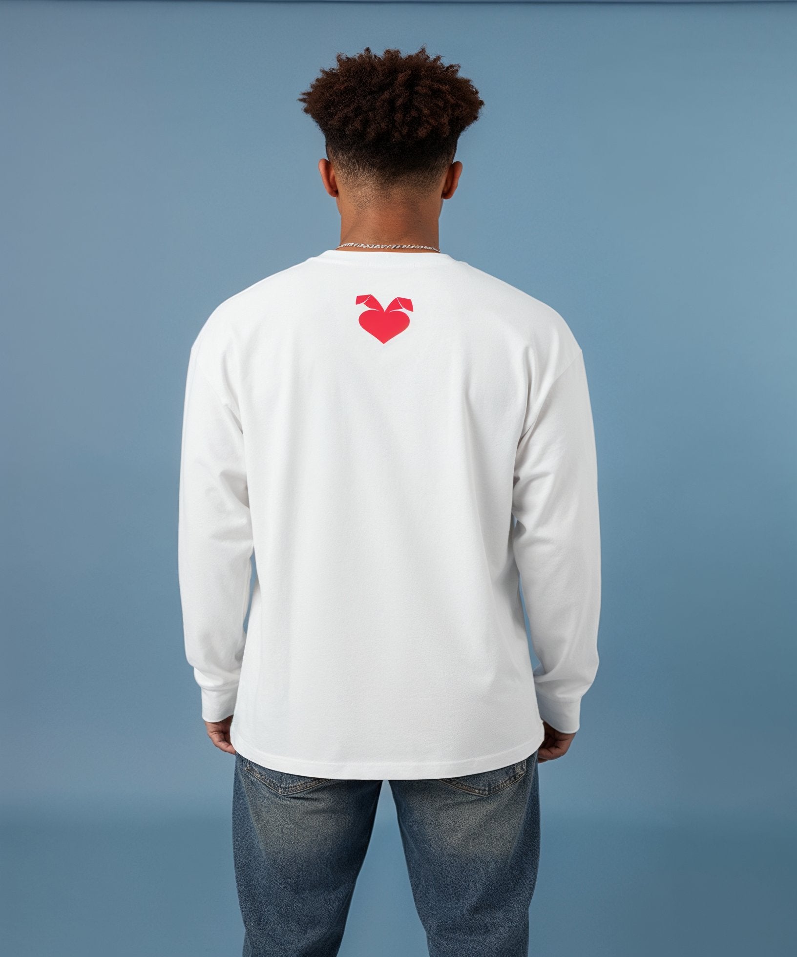 Person wearing a sweethearts white long-sleeve shirt with a red logo on the back against a blue background