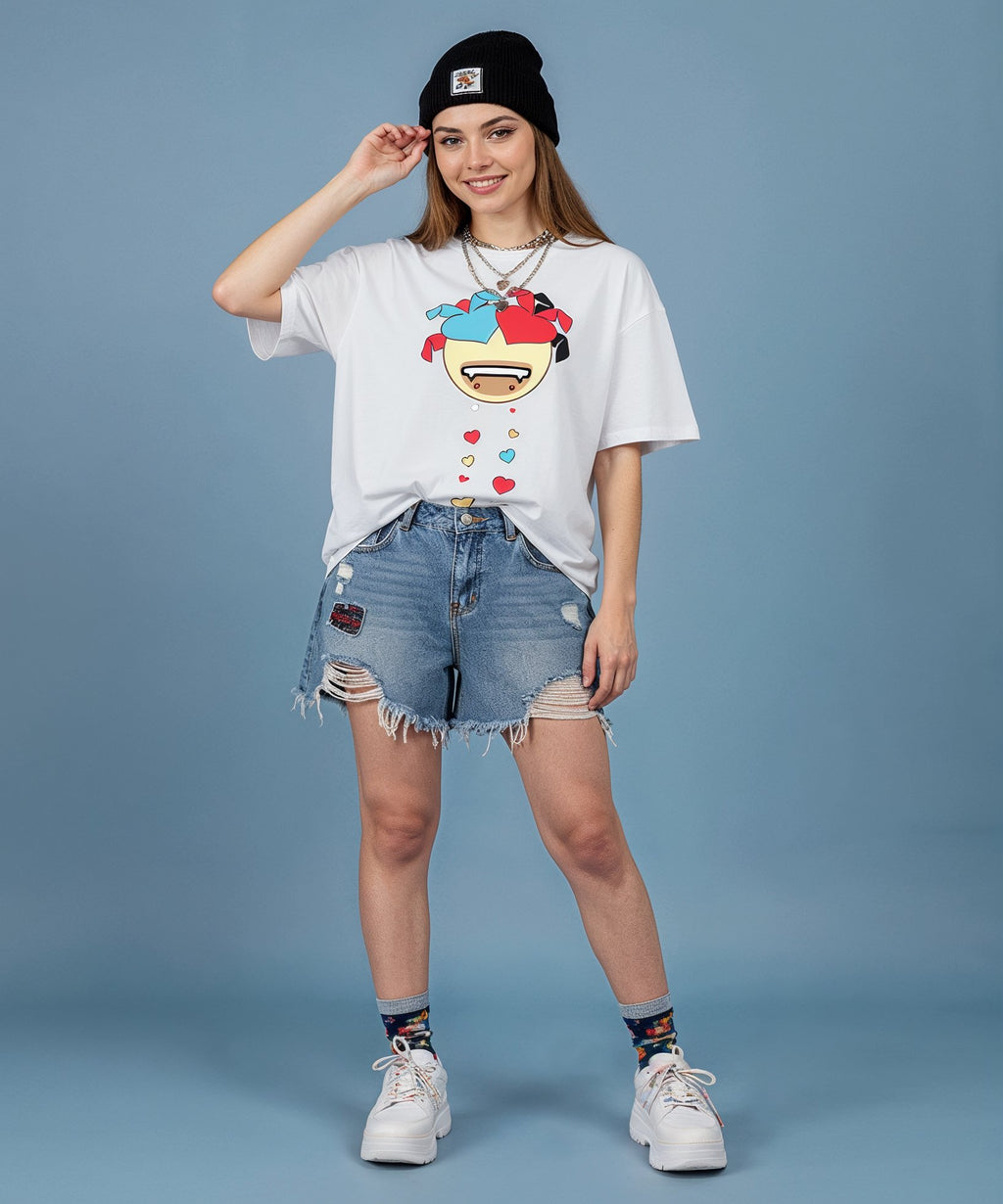 female wearing a sweethearts white t-shirt with a colorful graphic design and ripped jeans on a blue background. front view