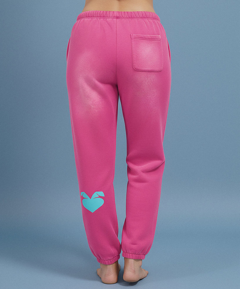 Pink sweatpants with sweethearts  'Baby!' text on a blue background, female back view