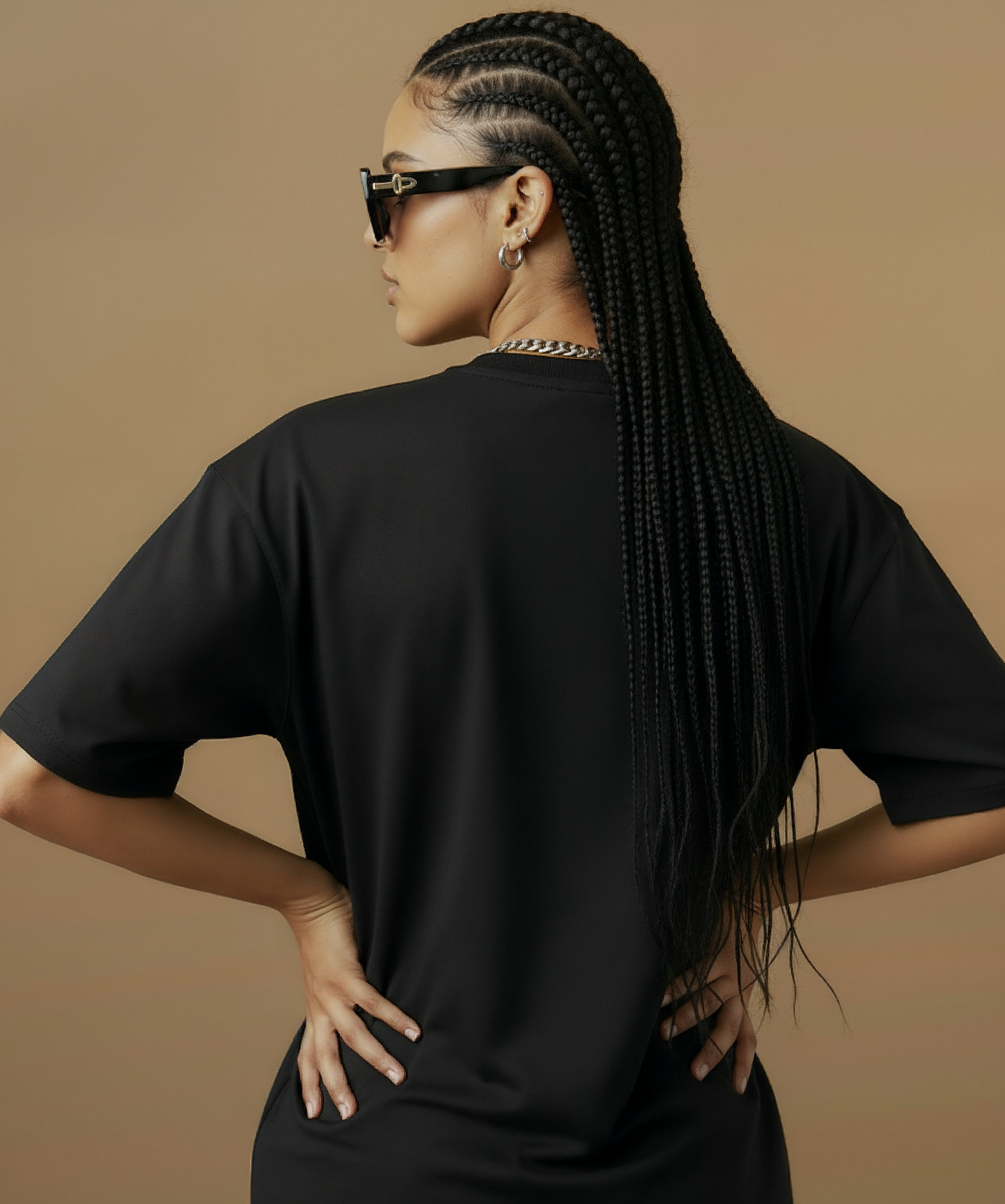 female model wearing a black t-shirt with  sweethearts brand 'FEELINGS MOODS' text on a brown background. back of shirt 