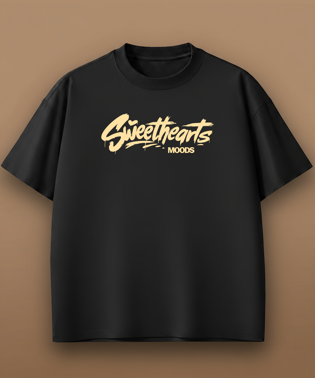Black t-shirt with yellow 'Sweethearts Moods' text on a brown background, front graphic
