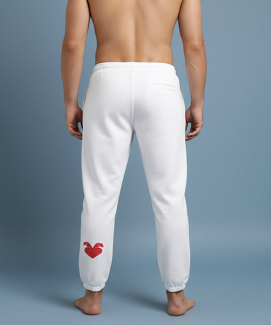 male wearing white sweatpants with a sweethearts red heart logo design on a blue background, back view