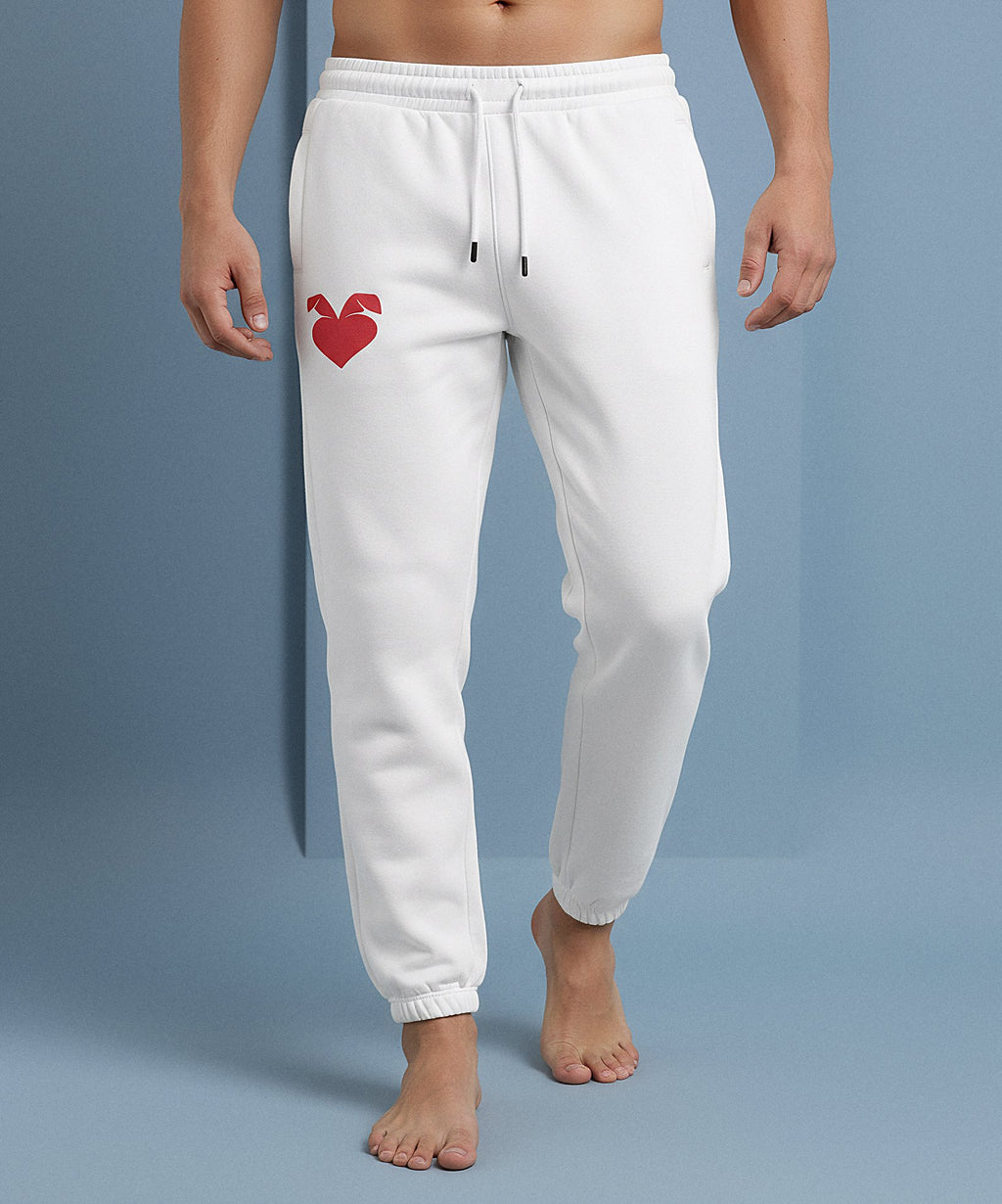 male wearing white sweatpants with a sweethearts red heart logo design on a blue background, front view