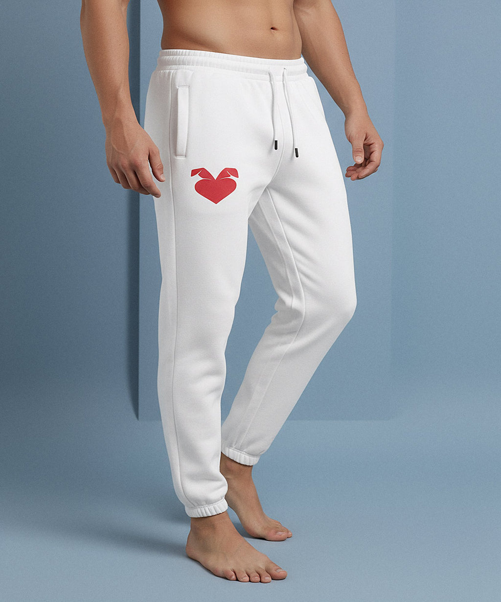 male wearing white sweatpants with a sweethearts red heart logo design on a blue background, side view