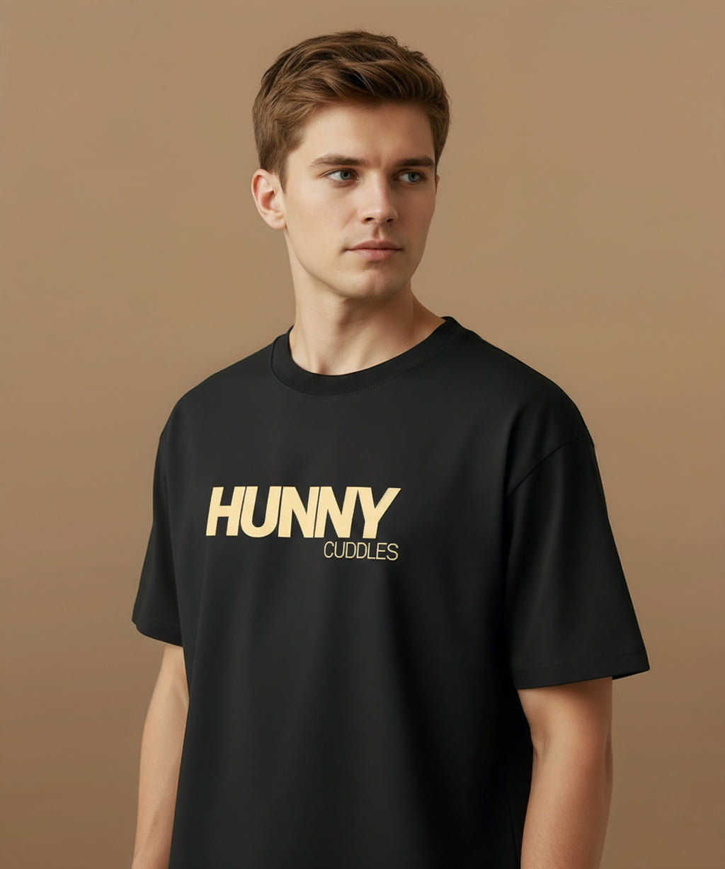 male model showing angled view of the tshirt design for hunny cuddles t shirt, against a brown background.