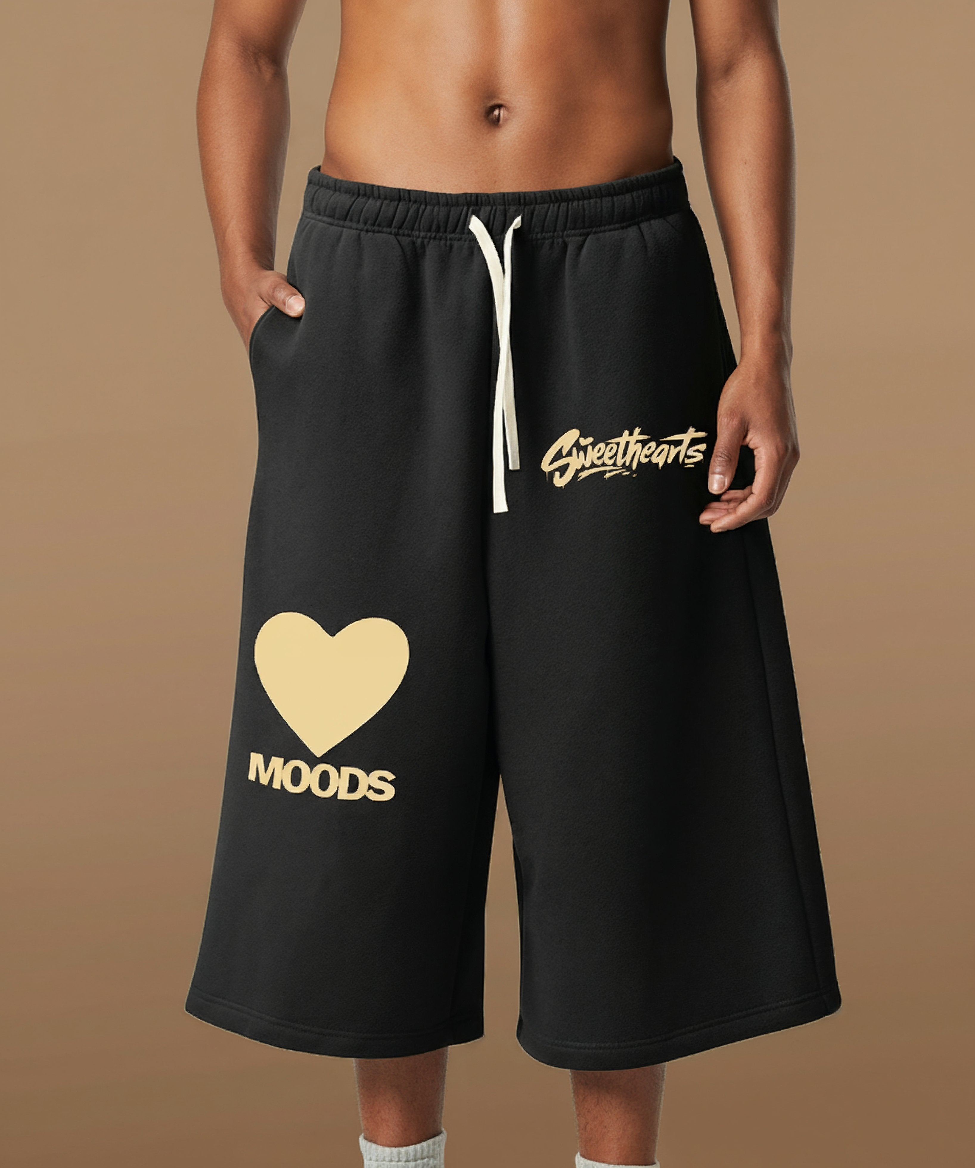 Sweethearts graffiti text and heart logo printed on black shorts from Moods Drop, male front view