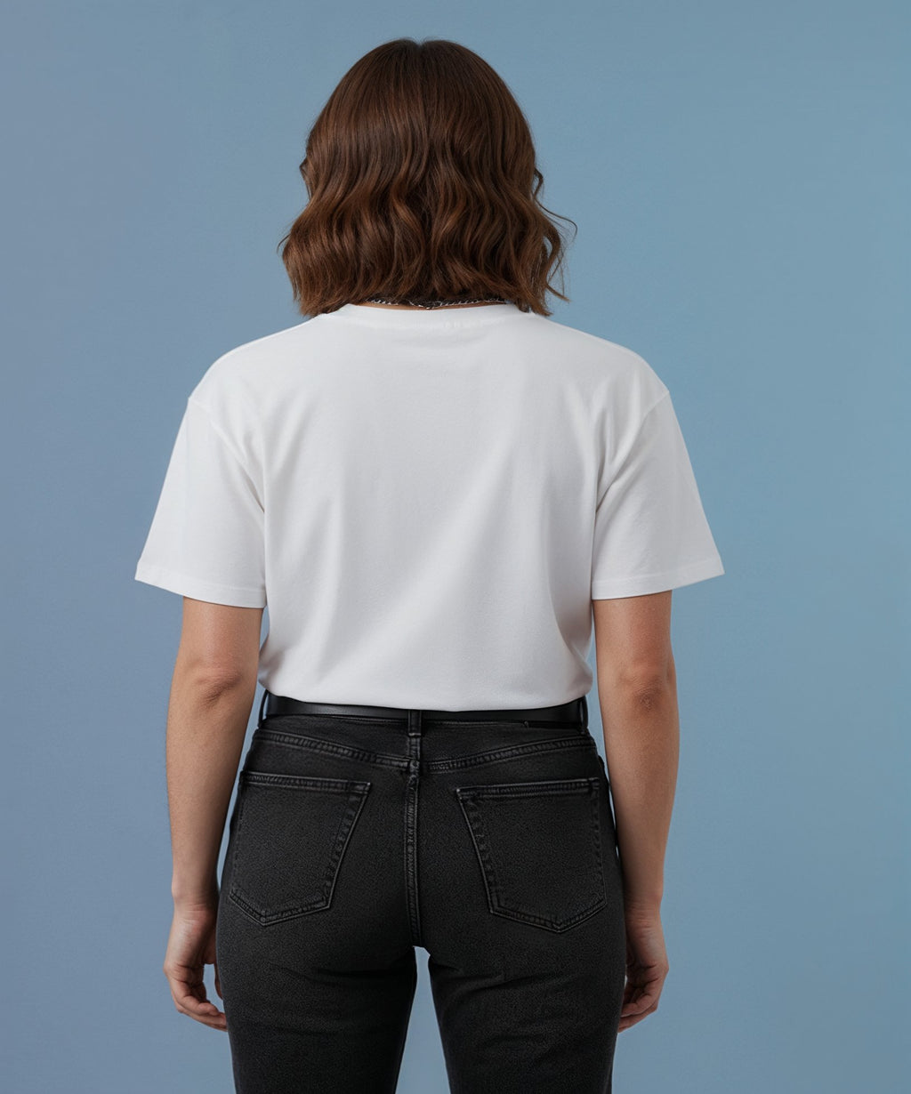 back view of a female wearing a white sweethearts t-shirt called pure love, against a blue background, no logos
