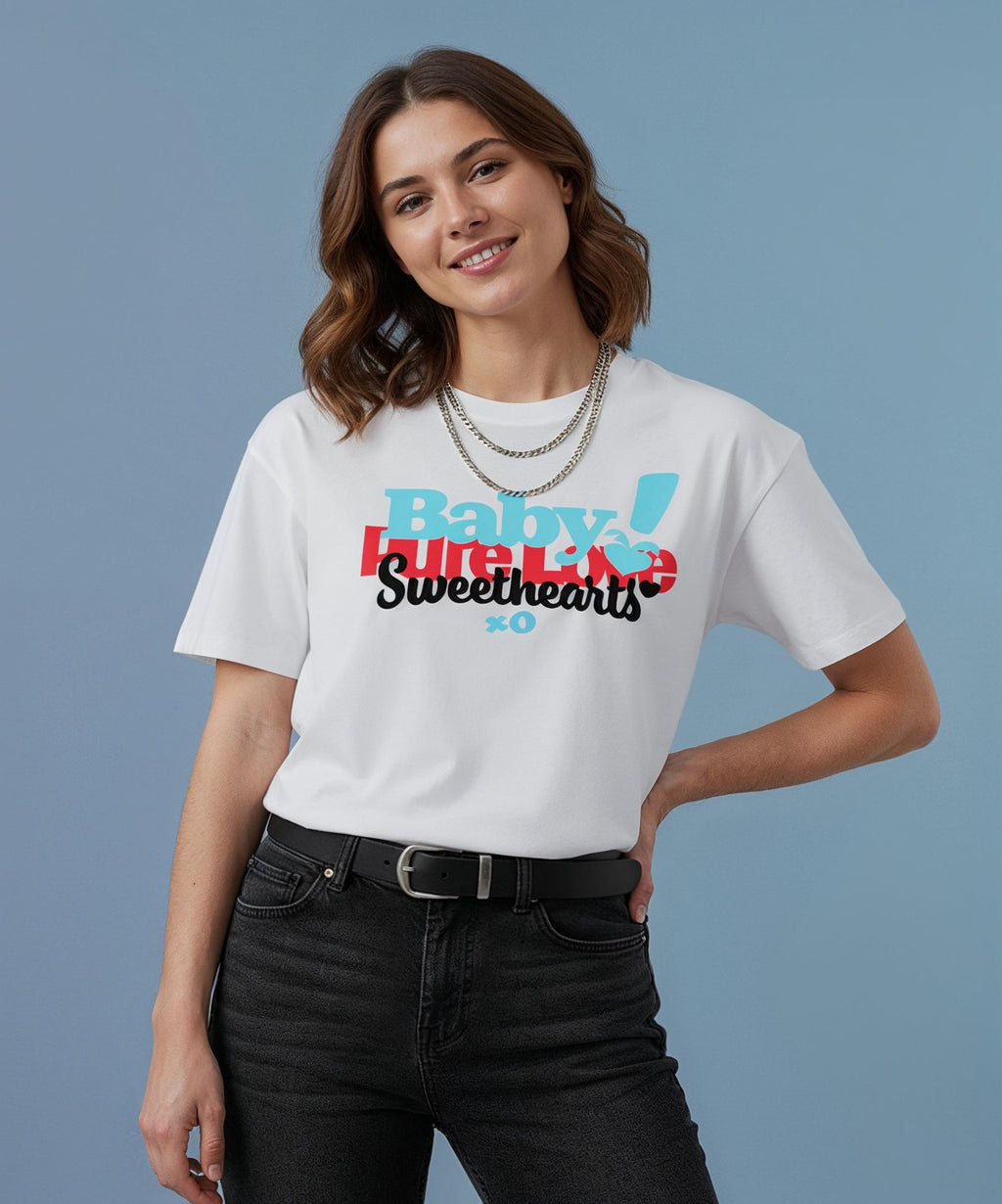 female wearing a white sweethearts t-shirt called pure love, against a blue background, front view
