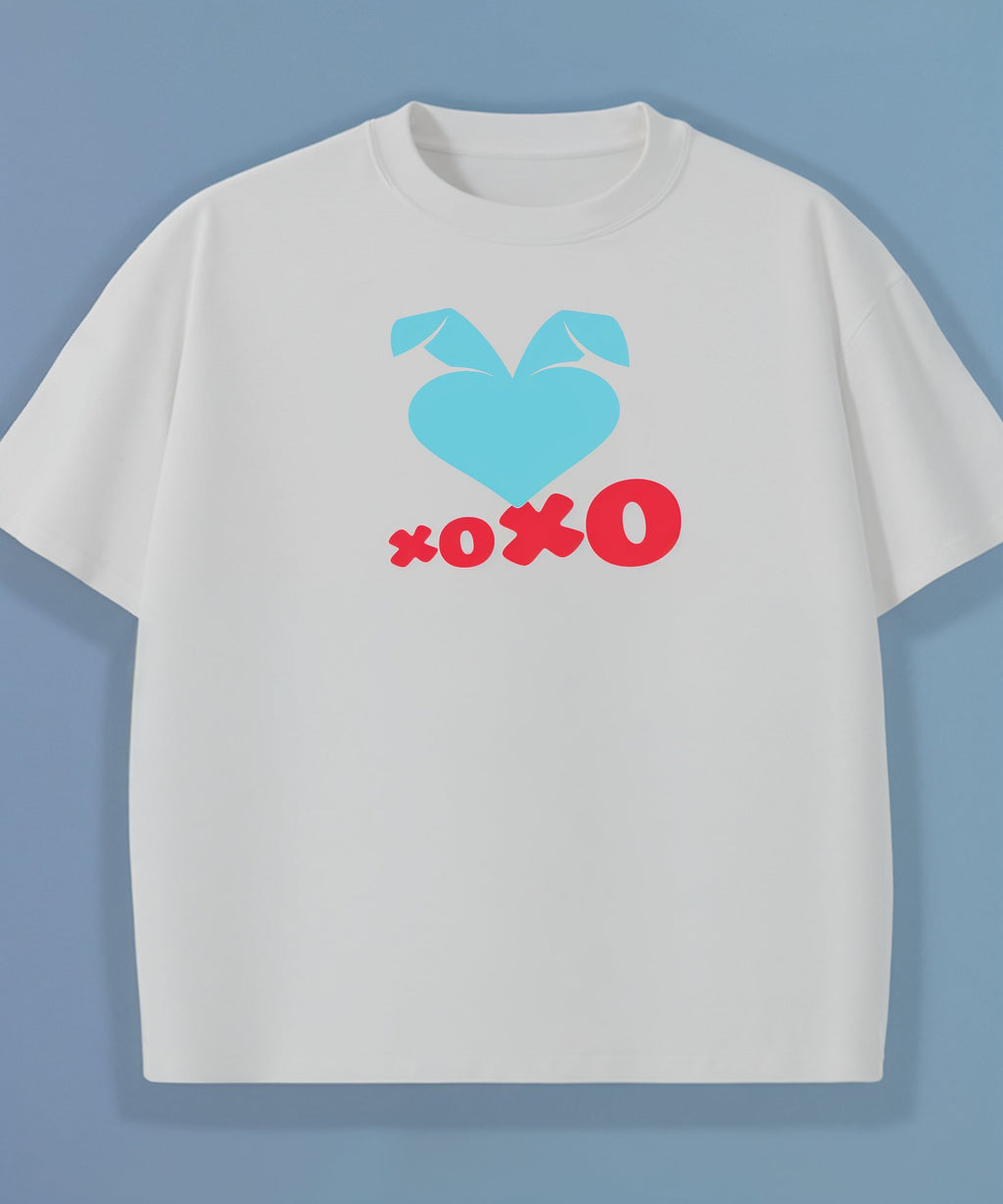 White t-shirt with blue heart and red 'xoxo' design and blue sweethearts heart logo on a light blue background
