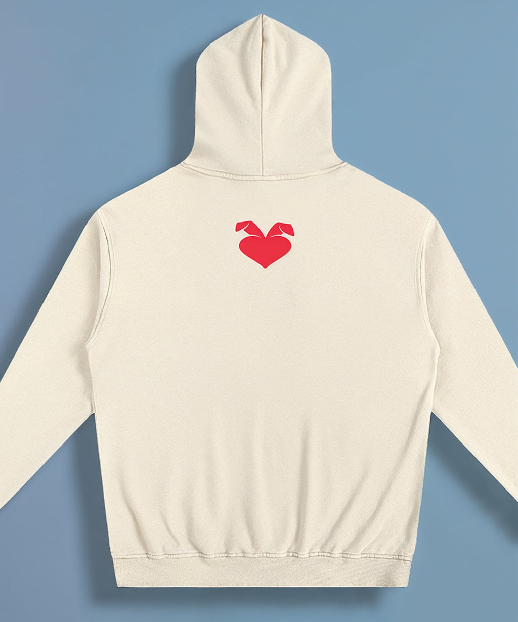 cream hoodie with a red heart design on the back against a blue background, back of hoodie