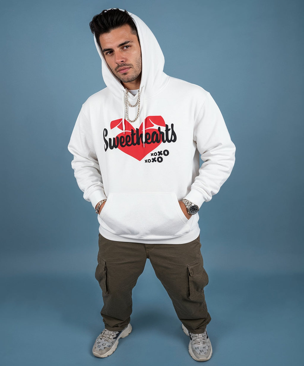 Man wearing a white hoodie with a sweethearts red heart logo and xoxo design and text on a blue background